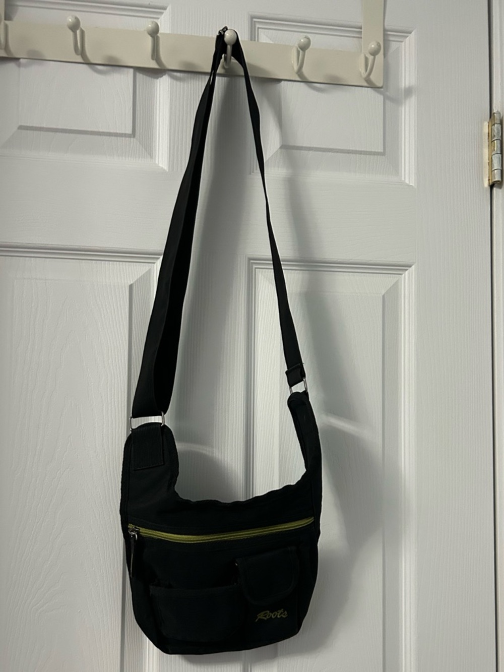 Roots Black Crossbody Bag with Green Zipper Accent